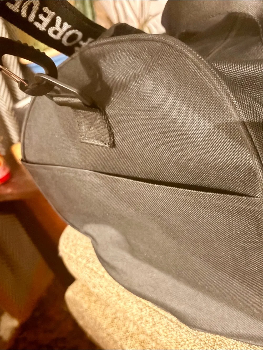 assholes live forever duffel logo